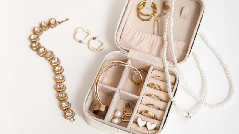 ChatGPT said:  Jewelry box with gold bracelets, rings, and pearl necklace.